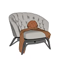 Stylish White Tufted Leisure Chair With Brown Knitted Pillow And Blanket On Black Metal Legs
