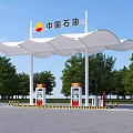 PetroChina Gas Station with White Canopy Fuel Dispensers and Green Trees Under Blue Sky