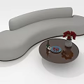 Gray Curved Sectional Sofa with Round Coffee Table Red Flowers Wine Bottle And Blue Plate