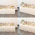 Elegant Food Display Table With Various Desserts Floral Decor And White Tablecloth