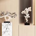 Modern Silver Sculptures On Marble Bases Against Wooden Wall With Vertical Stripes