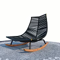 Black Woven Rocking Chair With Wooden Rocking Legs On Gray Floor