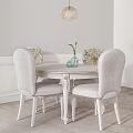 Elegant White Dining Table Set With Floral Chairs Hanging Lamp And Vase On Wainscoting Wall