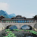 Traditional Chinese Stone Arch Bridge With Pavilions Over Water Featuring Lotus Leaves And Mountain Backdrop