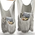 Cozy Light Gray Macramé Hanging Chair With Fringes And Patterned Pillows