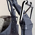 Chic Leather Storage Baskets with Black Handles Holding Firewood and Blanket Tassels