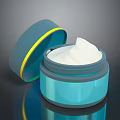 Open Blue Cream Jar With Yellow Accent And White Cream Inside