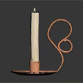 Decorative Copper Candlestick Holder With Curved Design And Lit White Candle