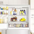 Open Refrigerator Filled With Various Food Drinks And Fresh Produce In Kitchen