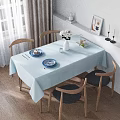 Bright Sunlit Minimalist Dining Room With Natural Wood Chairs And Soft Light Blue Tablecloth