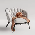 Stylish White Tufted Leisure Chair With Brown Knitted Pillow And Blanket On Black Metal Legs