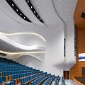 Cultural Center Auditorium Interior With Blue Seats Curved White Ceiling And Wooden Walls