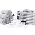 Gray Cotton Towels Rolled And Stacked With Marble Tray And Toiletries