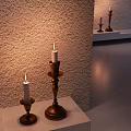 Decorative Ornament Set With Lit Candles On Wooden Candlesticks Of Different Heights And Textured Wall