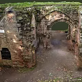 Ancient Stone Ruins Featuring Arched Doorway And Moss Covered Historical Walls