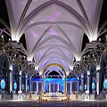 Elegant Banquet Hall Interior With Arched Ceiling Purple White Lighting And Decorative Chandeliers