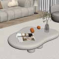 White Curved Coffee Table in Modern Living Room with Magazine Oranges Clear Vase and Plant