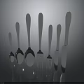 Silver Cutlery With Spoons Forks Knives Neatly Arranged In Various Sizes On Dark Reflective Surface