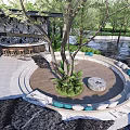 Garden Landscape With Circular Seating Area Green Plants Trees Rocks Bar Counter Water Feature