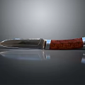 Tactical Weapon Knife With Metal Blade Red Wooden Handle And Silver Fitting On Reflective Surface