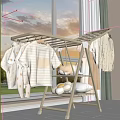 Indoor Clothes Drying Rack With Baby Clothes Striped T-shirt And Plush Toys In Natural Light