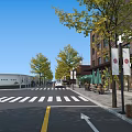 Scenic Tree Lined Commercial Street With Modern Buildings Shops Crosswalk Pedestrians And Cars