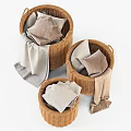 Three Woven Storage Baskets With Folded Clothes And Towels For Home Organization