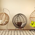Three Stylish Rattan Hanging Chairs With Different Designs And Colorful Cushions In Indoor Living Space