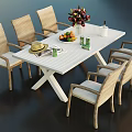 White Dining Table Set With Six Rattan Chairs Flower Arrangement Fruit Platter And Straw Hat