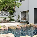 Garden Landscape with Small Pond Stones Green Trees White Building Lattice Wall and Patio Seats
