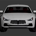 Silver Maserati Sedan With Sleek Design And Black Wheels On Reflective Surface