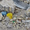 Pile of Construction Debris With Rubble Bricks Metal Sheets Yellow Blue Buckets And Dirt Path