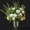 Glass Vase Arrangement With White Roses Green Leaves And Small Flowers