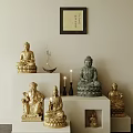 Golden Green Buddha Sculptures Carvings On White Display Stands With Lit Candles Incense And Calligraphy