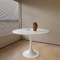 White Round Dining Table With Clay Vase On Wooden Floor By Beige Wall And Blinds