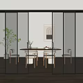 Modern Black Framed Glass Sliding Doors In Home Dining Area With Wooden Table And Plants