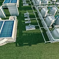 Aerial View Of Industrial Plant With Cooling Towers Storage Tanks Piping Systems On Green Grass