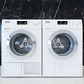 Two Haier White Front Load Washing Machines With Control Panel And Stainless Steel Door
