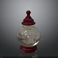 Transparent Glass Jar With Red Lid And Smooth Reflective Body On Base