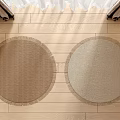 Two Woven Round Rugs With Fringed Edges On Light Wooden Floor