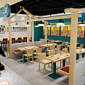 Nanniwan Noodle Restaurant Interior With Counter Seating Wooden Shelves And Decor