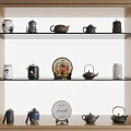 Traditional Tea Sets Display On Wooden Shelves With Various Teapots And Tea Cakes