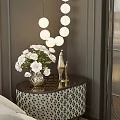 Stylish Bedside Table With Black Tabletop White Vase Flowers And Golden Decor