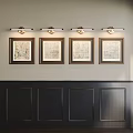 Interior Wall With Four Framed Map Artworks And Wall Sconces Above Dark Wainscoting