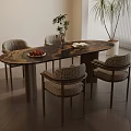 Oval Dining Table Set With Woven Chairs Fruit Plate And Green Plant Decor