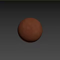 Brown Sphere Component On Wooden Tabletop Against Textured Brown Wall