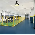 Factory Workshop Interior With Yellow Fences Machine Tools Green Floor And Hanging Lamps