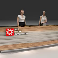Modern Wooden Striped Reception Desk With The Solar Revolution Logo And Two Receptionists Behind