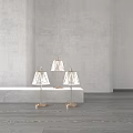 Three Elegant Crystal Lamps With Gold Base And Transparent Shade On Gray Display Stand