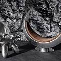 Stylish Silver Metallic Leisure Chairs with Crescent Design and Brown Cushion Against Rock Wall